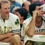 ** FILE ** Boston Celtics, from left, Robert Parish, Larry Bird, and Kevin McHale watch their team win over the Washington Bullets at the Boston Garden, in Boston, in this Nov. 30, 1991, file photo. Don't call them the Big Three yet. Paul Pierce, Kevin Garnett and Ray Allen aren't at the level of Larry Bird, Kevin McHale and Robert Parish when they led the Celtics to championships in the 1980s. But the new trio of stars would move Boston much closer to a shot at an NBA title. (AP Photo/Stephan Savoia, File)